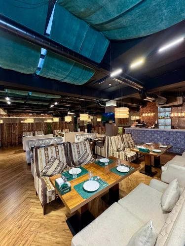 a dining room with a table and chairs at Arda Plaza Hotel in Tashkent