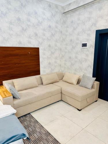 a living room with a couch in a room at Arda Plaza Hotel in Tashkent