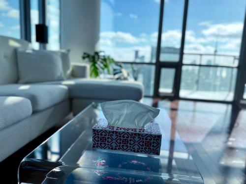 a box on a glass table in a living room at 44th Floor, Panoramic Views, Bay Corridor Downtown Toronto Condo in Toronto