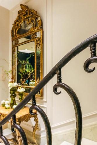a stairway with a mirror on the wall at Hotel Montalembert in Paris