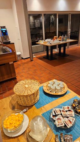 a table with many plates of food on it at Aparthotel Höper in Oyten