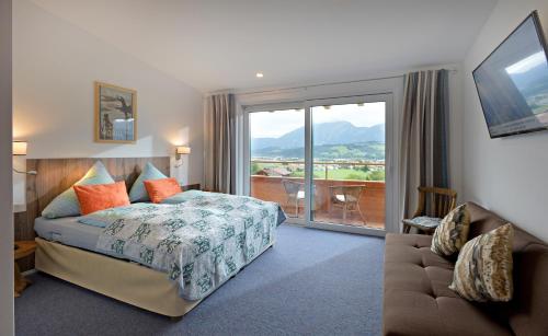 a hotel room with a bed and a balcony at Be 550 in Wörgl