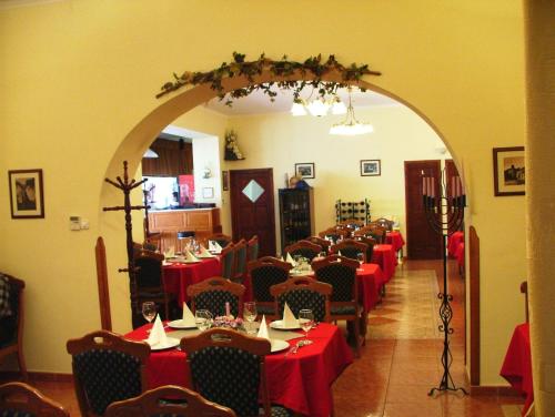 a dining room with tables with red table cloth at Rákóczi Panzió in Sárospatak