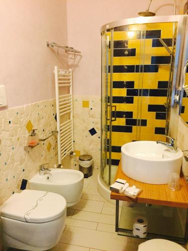 a bathroom with a sink and a toilet and a shower at Hotel Zodiaco in Porto Cesareo