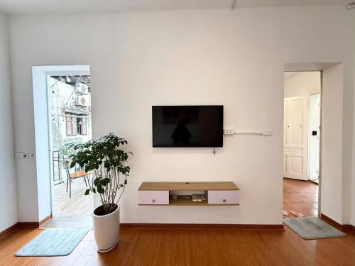 a living room with a flat screen tv on a wall at Vodka Apartment in Hanoi