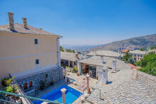a house with a swimming pool next to a building at Palladio Hotel - Portaria in Portaria