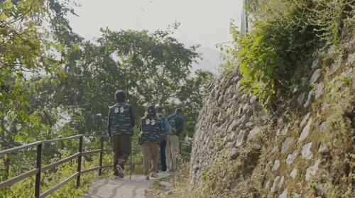 a group of people walking down a stone wall at The Solluna Resort in Marchula