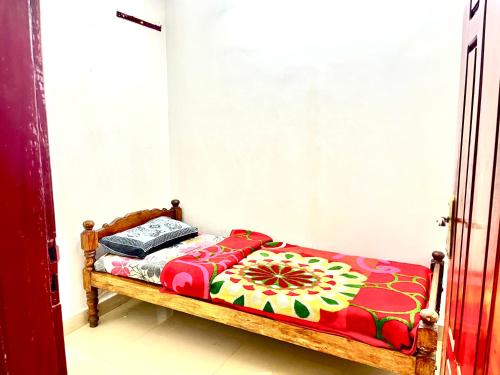 a bedroom with a bed with a flower pattern on it at GlenBrook HomeStay in Munnar