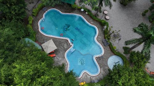an overhead view of a swimming pool in a resort at The Solluna Resort in Marchula