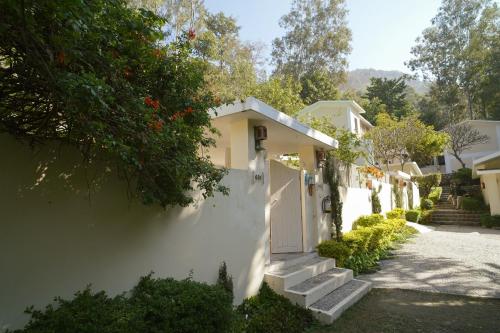 a white house with a white gate and stairs at The Solluna Resort in Marchula