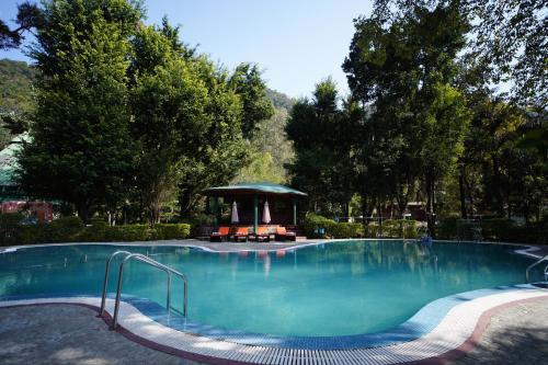 a large swimming pool with a gazebo in a park at The Solluna Resort in Marchula
