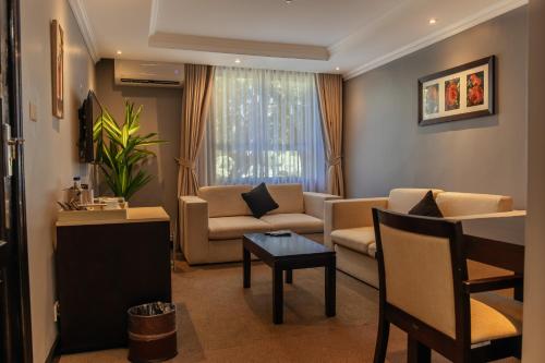 a living room with a couch and a table at Cresta Lodge Gaborone in Gaborone