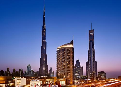 a view of a city skyline at night at Paradise View The Dubai Mall Residences in Dubai