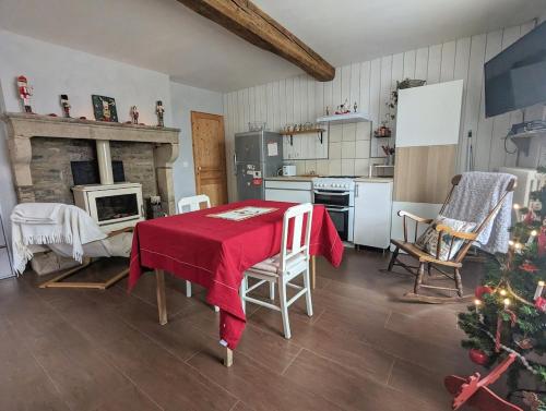 a kitchen with a table and a christmas tree in it at La maison d'en face a cozy guesthouse in Saint-Euphrône