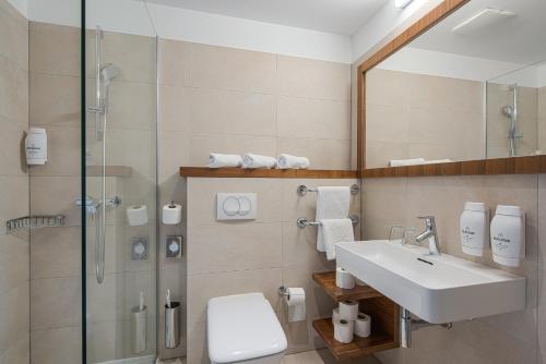 a bathroom with a sink and a shower at Hotel Katarina in Selce