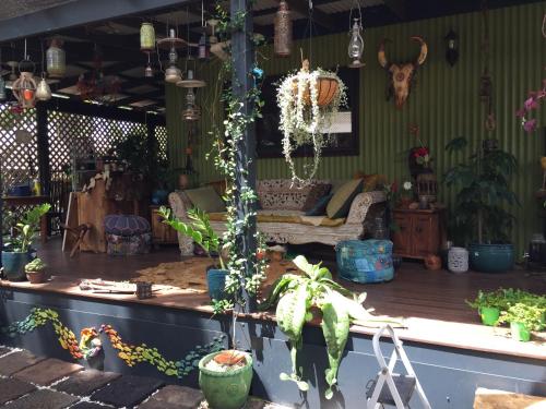 a living room filled with lots of potted plants at Broome bohemian poolside retreat in Cable Beach