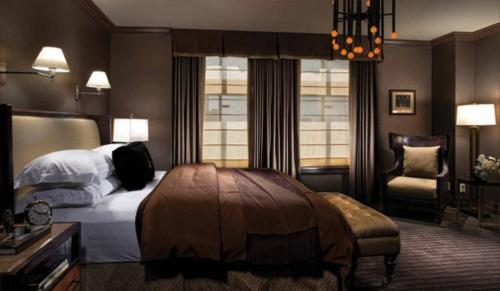 a hotel room with a bed and a chair at Los Angeles Athletic Club in Los Angeles