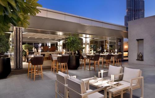 a restaurant with tables and chairs on a patio at Paradise View The Dubai Mall Residences in Dubai