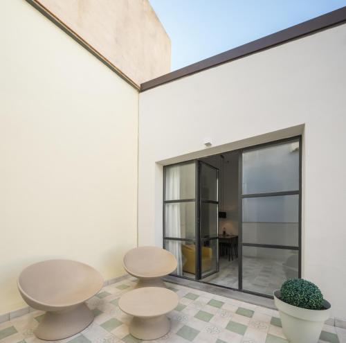 two tables and two chairs in a room with a window at Fetén in Valencia