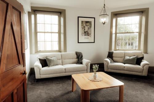 a living room with two couches and a coffee table at Charming 2-Bed Apartment in Launceston CBD in Launceston