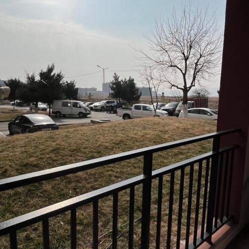 a balcony with cars parked in a parking lot at Mika's Apartment in Tbilisi City
