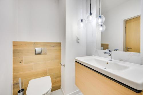 a bathroom with a sink and a toilet at ReVital Mechelinki by Homeprime Parking Free in Mechelinki