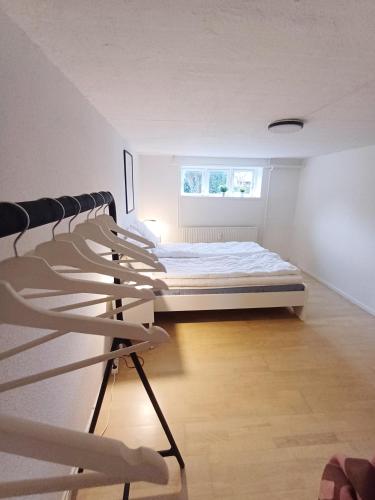 a room with a bed and chairs in it at Central Apartment In Aalborg Close To Hospital in Aalborg