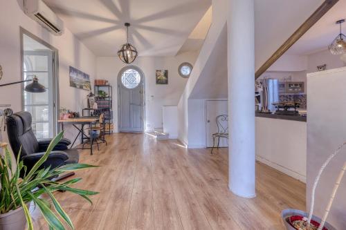 un grand salon avec une colonne et une table dans l'établissement La Tartane - Maison climatisée proche plage, à Toulon