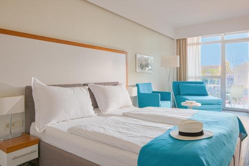 a bedroom with a bed with a hat on it at Hotel Katarina in Selce