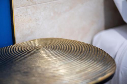 a close up of a wooden seat in a room at Napoleon Suites & Apartments in Susa