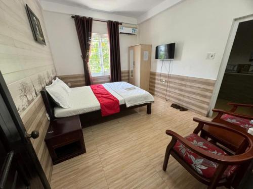une petite chambre avec un lit et une chaise dans l'établissement Trường Ân Homestay, à Hue