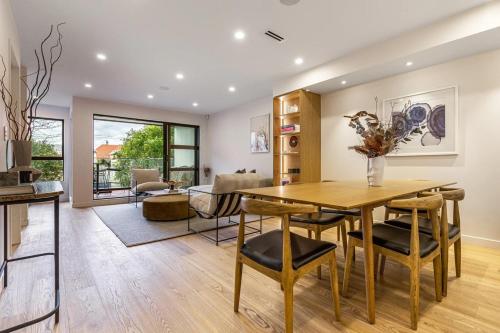 a kitchen and dining room with a table and chairs at Mission Bay 4 bedrooms Tidy Unit in Auckland