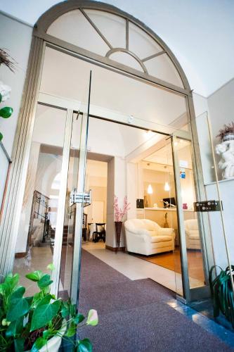 a living room with a glass door leading into a living room at Hotel Principe in Casale Monferrato