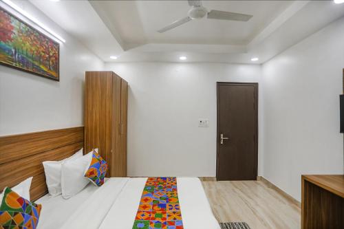 a bedroom with a bed and a ceiling fan at FabHotel Unique Stay in Noida