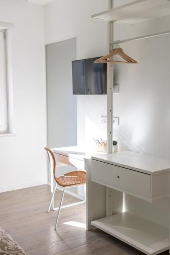 a white desk and a chair in a room at Casa Irene in Loreto