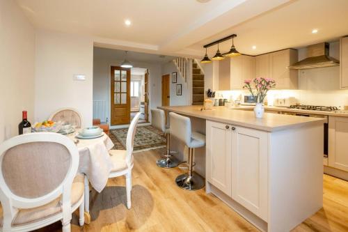 a kitchen and dining room with a table and chairs at 7 Prospect Place - Aldeburgh Coastal Cottages in Leiston