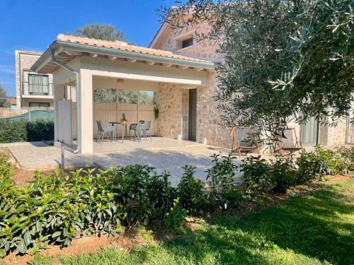 a house with a patio with a table and chairs at YANNIS RETREAT in Lefkada Town