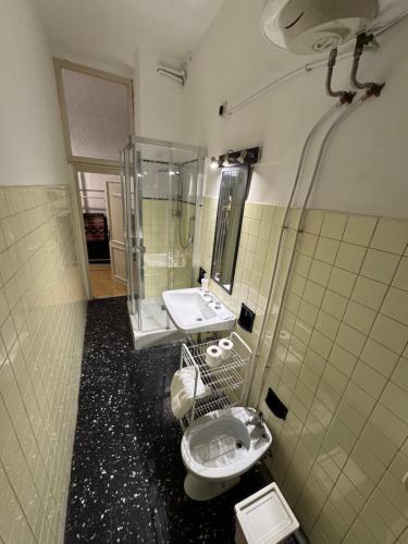 a bathroom with a toilet and a sink and a shower at Charming large palazzo in center Venice for up to 9 people in Venice