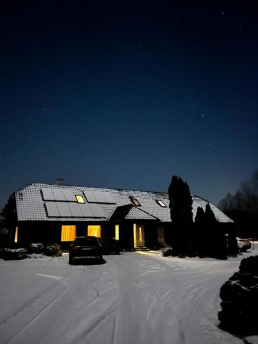a house with a solar roof in the snow at Kiisa Jahi- ja Matkamaja in Holvandi