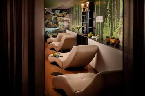a row of chairs and tables in a room at Avani Palazzo Moscova Milan Hotel in Milan