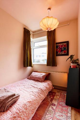 a bedroom with a bed and a window at Cosy home in Chapel Allerton Area - Peaceful Street, Free Parking in Leeds