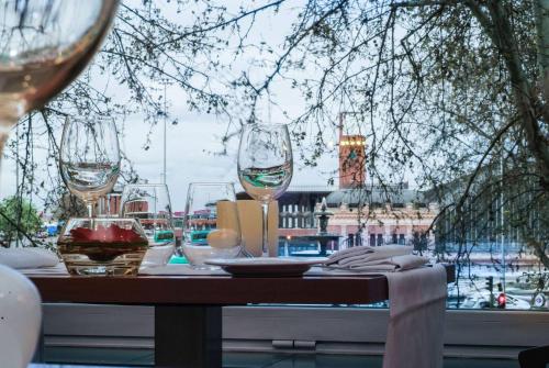 a table with wine glasses sitting on top of it at NH Madrid Nacional in Madrid