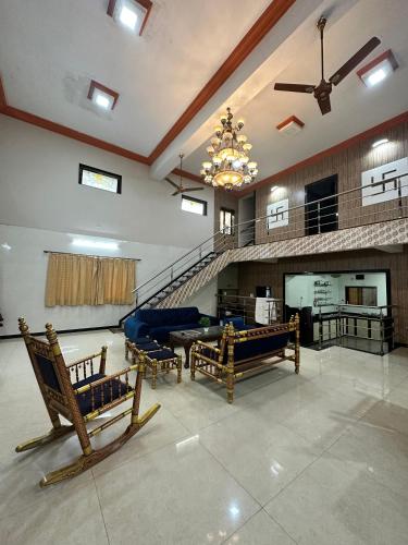 a large living room with couches and a chandelier at Airspace villa in Igatpuri