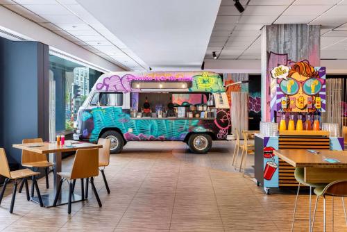 a food truck parked in a restaurant with tables and chairs at nhow Brussels Bloom in Brussels
