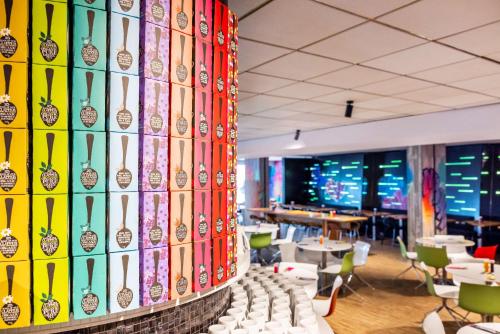 a bunch of soda bottles on the wall of a restaurant at nhow Brussels Bloom in Brussels