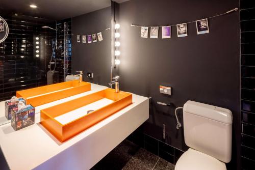 a bathroom with a sink and a toilet at nhow Brussels Bloom in Brussels