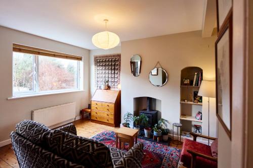 a living room with a couch and a tv at Cosy home in Chapel Allerton Area - Peaceful Street, Free Parking in Leeds