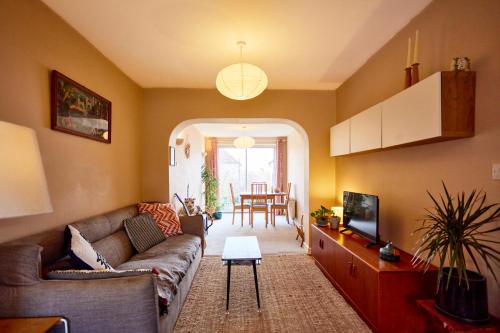 a living room with a couch and a table at Cosy home in Chapel Allerton Area - Peaceful Street, Free Parking in Leeds