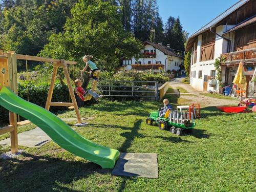 a group of children playing on a playground at Moosbachhof - Ferienwohnung Marienkäfer in Collalbo