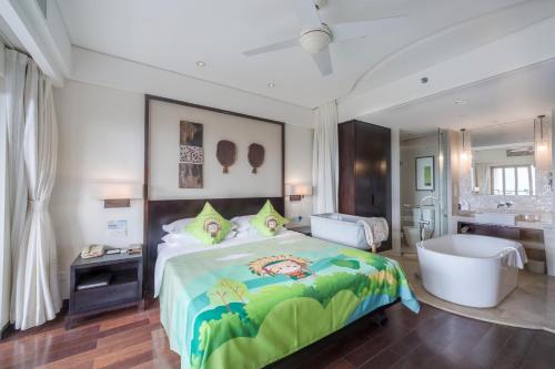 a bedroom with a large bed and a bathroom at Howard Johnson Resort Sanya Bay in Sanya